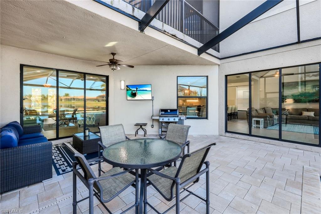 2735 Cinnamon Bay Circle Naples, FL 34119 - Photo 19 of 50 a dining room with furniture a chandelier and a rug
