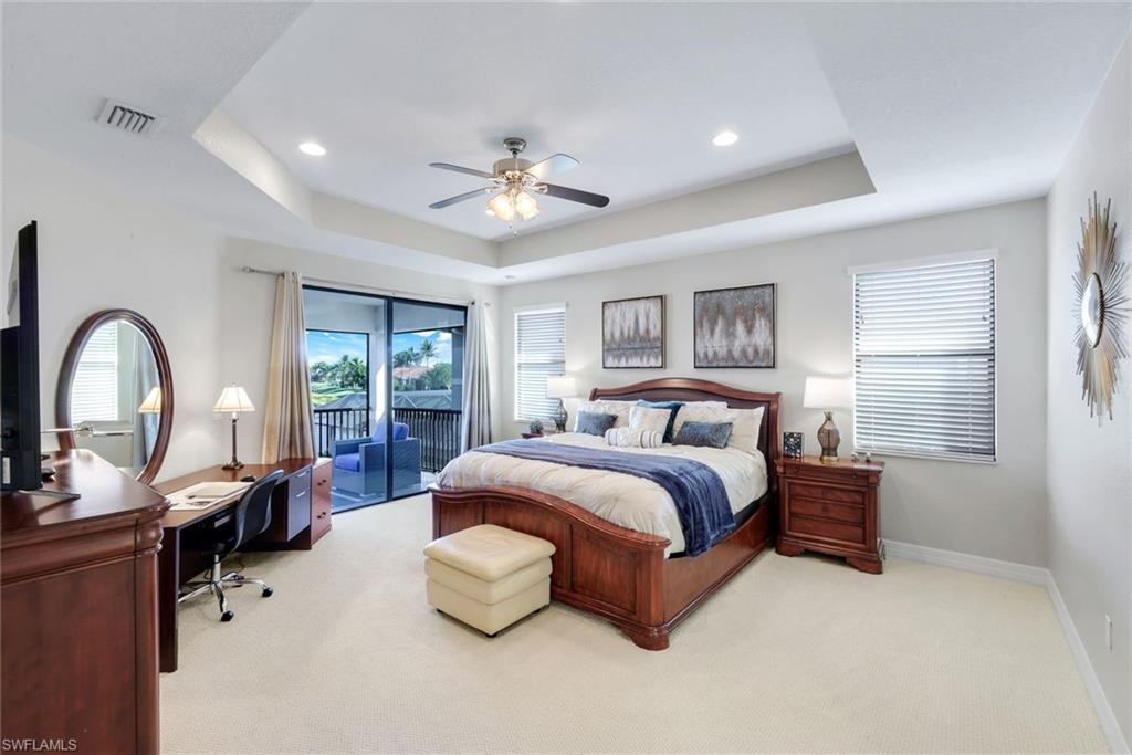 2735 Cinnamon Bay Circle Naples, FL 34119 - Photo 20 of 50 a spacious bedroom with a bed couch and a large window