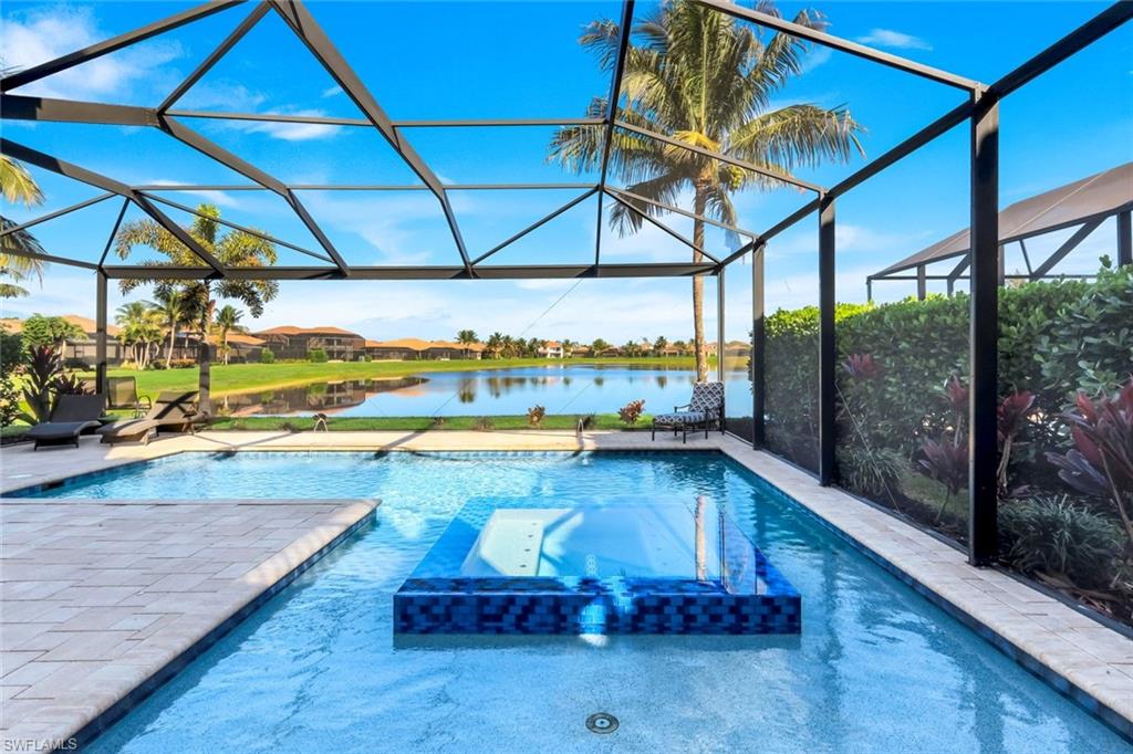 2735 Cinnamon Bay Circle Naples, FL 34119 - Photo 2 of 50 a view of a swimming pool with a patio
