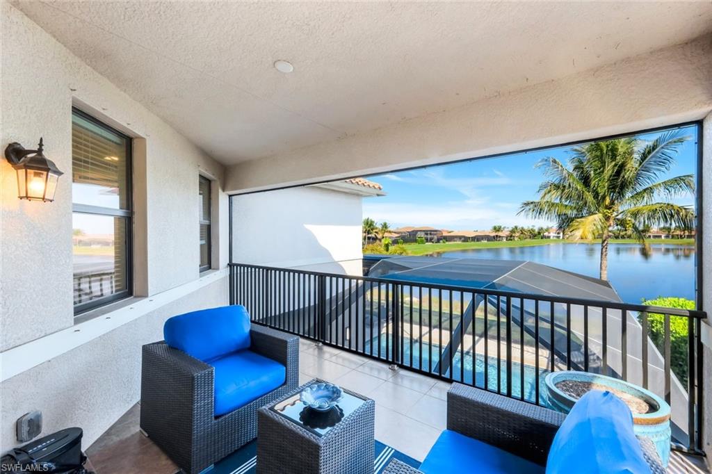 2735 Cinnamon Bay Circle Naples, FL 34119 - Photo 25 of 50 a balcony with furniture and wooden floor
