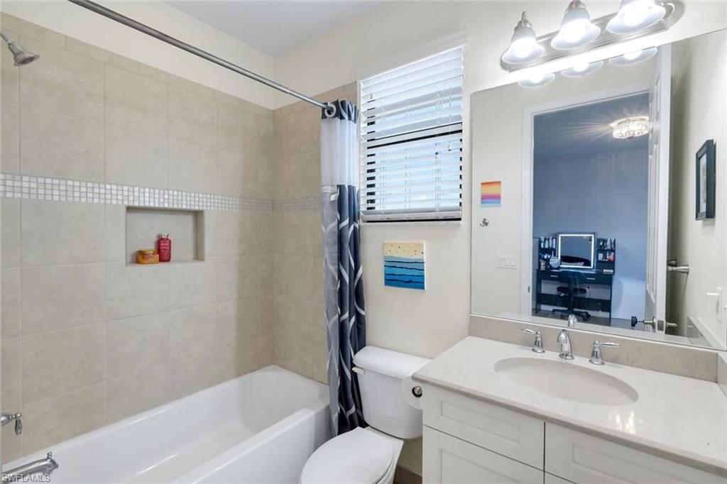 2735 Cinnamon Bay Circle Naples, FL 34119 - Photo 27 of 50 a bathroom with a tub shower sink and a mirror