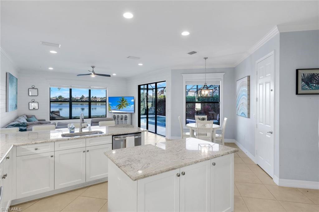 2735 Cinnamon Bay Circle Naples, FL 34119 - Photo 3 of 50 a kitchen with white cabinets and counter space
