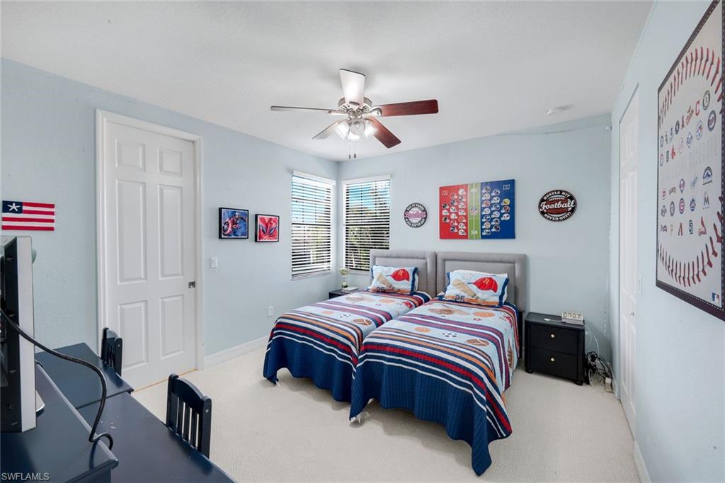 2735 Cinnamon Bay Circle Naples, FL 34119 - Photo 31 of 50 a bedroom with a bed and dresser with cabinet