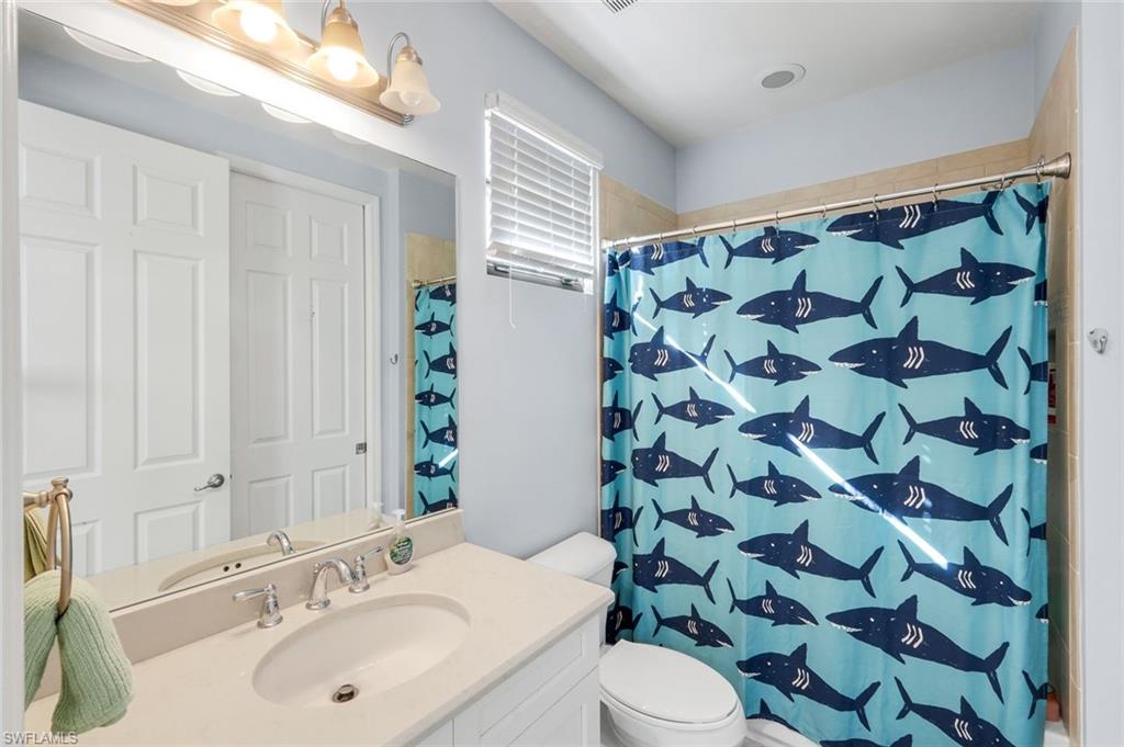 2735 Cinnamon Bay Circle Naples, FL 34119 - Photo 32 of 50 a bathroom with a sink and a mirror