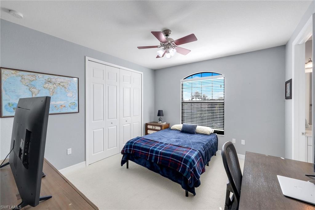 2735 Cinnamon Bay Circle Naples, FL 34119 - Photo 33 of 50 a bedroom with a bed and wooden floor