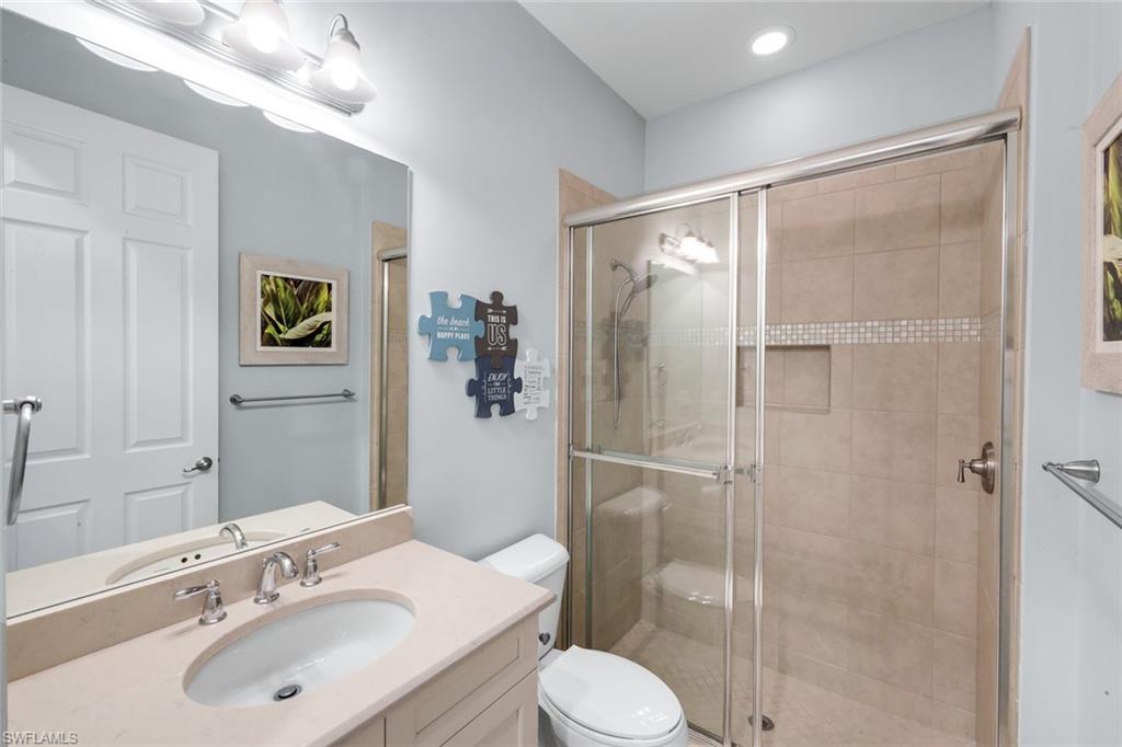 2735 Cinnamon Bay Circle Naples, FL 34119 - Photo 34 of 50 a bathroom with a sink toilet and shower