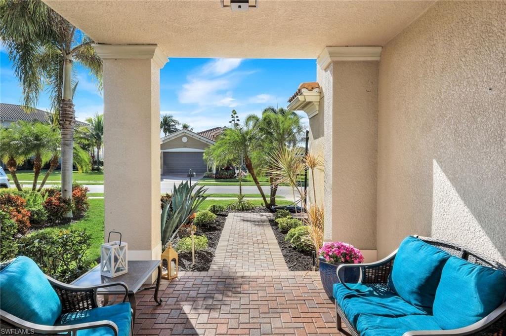 2735 Cinnamon Bay Circle Naples, FL 34119 - Photo 37 of 50 a view of a porch with furniture and a potted plant