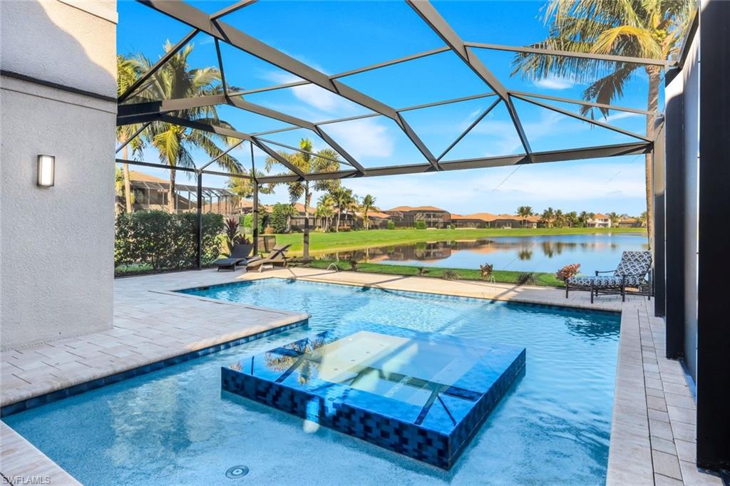 2735 Cinnamon Bay Circle Naples, FL 34119 - Photo 4 of 50 a view of a swimming pool with a patio