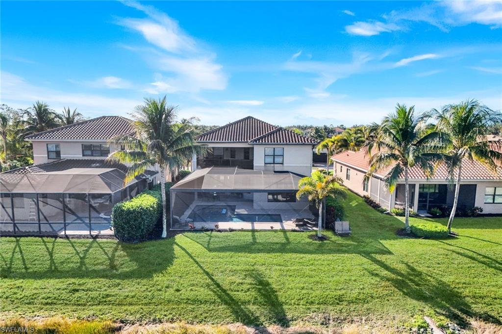 2735 Cinnamon Bay Circle Naples, FL 34119 - Photo 41 of 50 front view of house with a yard