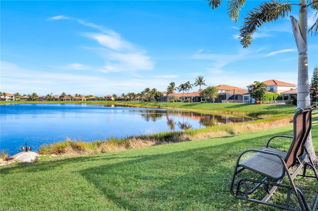 2735 Cinnamon Bay Circle Naples, FL 34119 - Photo 42 of 50 a view of a lake with lawn chairs