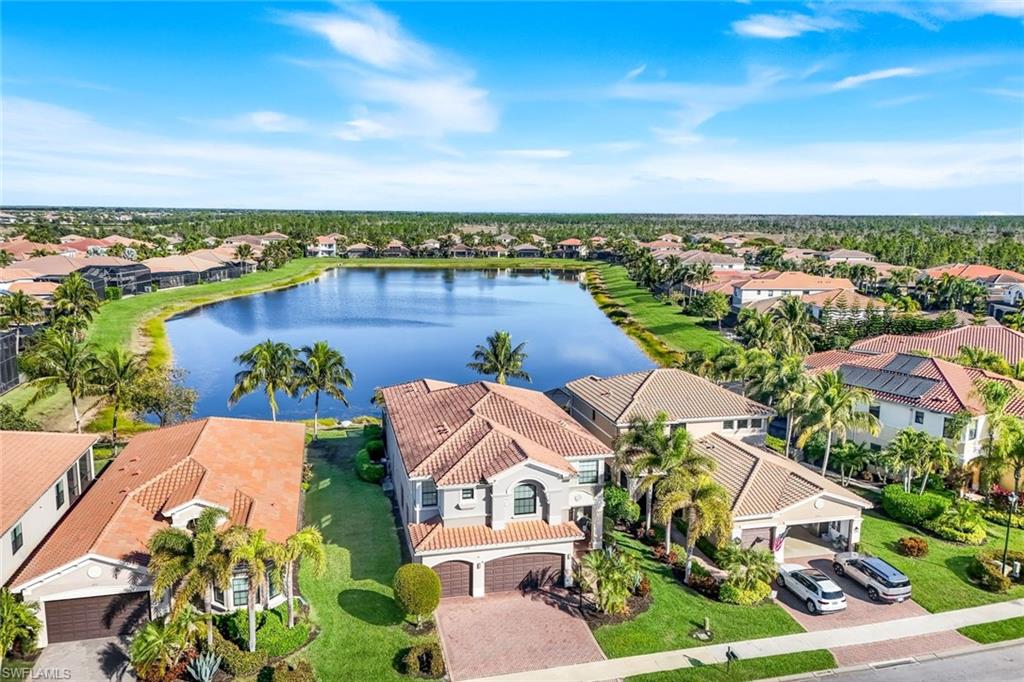 2735 Cinnamon Bay Circle Naples, FL 34119 - Photo 44 of 50 an aerial view of house with yard and ocean view