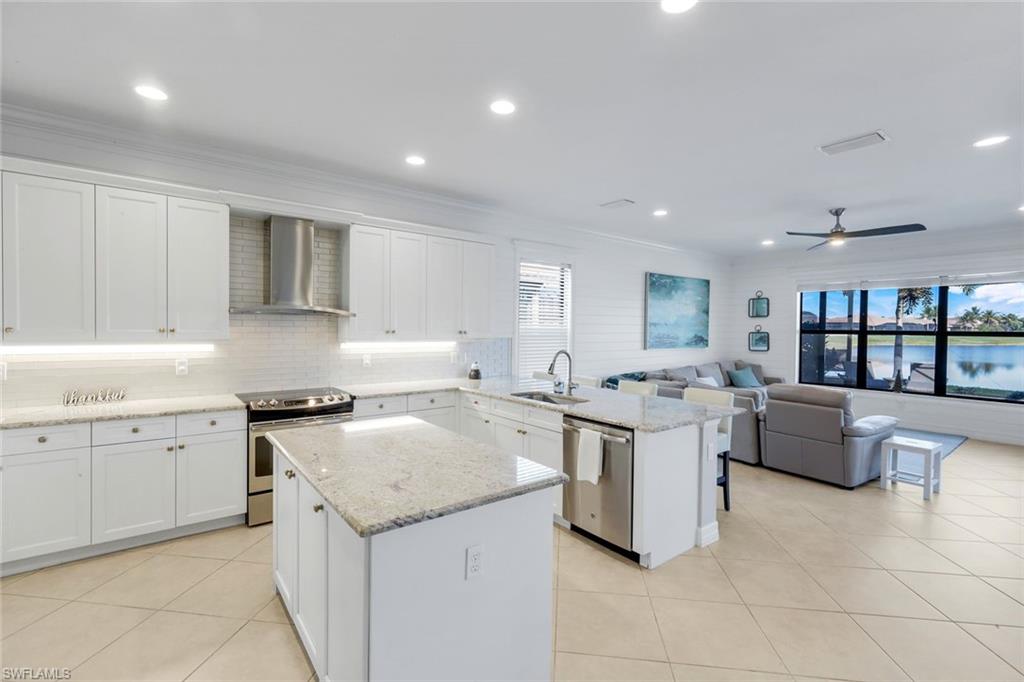 2735 Cinnamon Bay Circle Naples, FL 34119 - Photo 5 of 50 a kitchen with a sink stove and cabinets