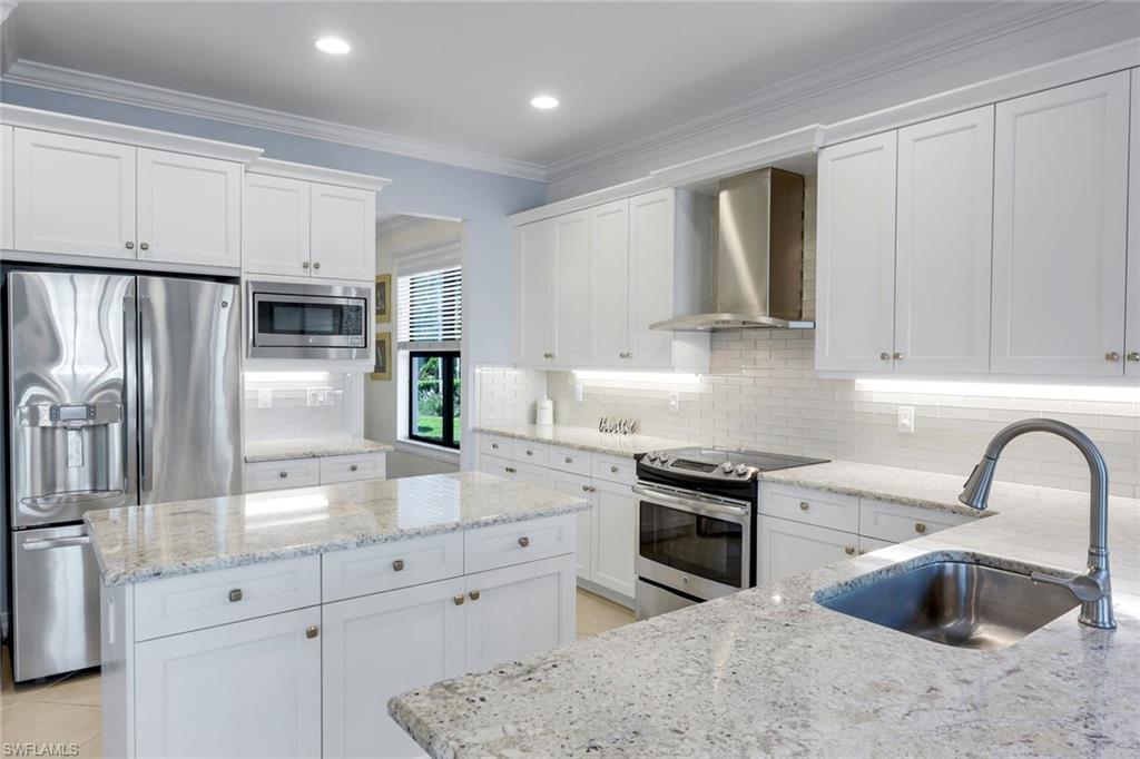 2735 Cinnamon Bay Circle Naples, FL 34119 - Photo 7 of 50 a kitchen with granite countertop a sink stainless steel appliances and cabinets