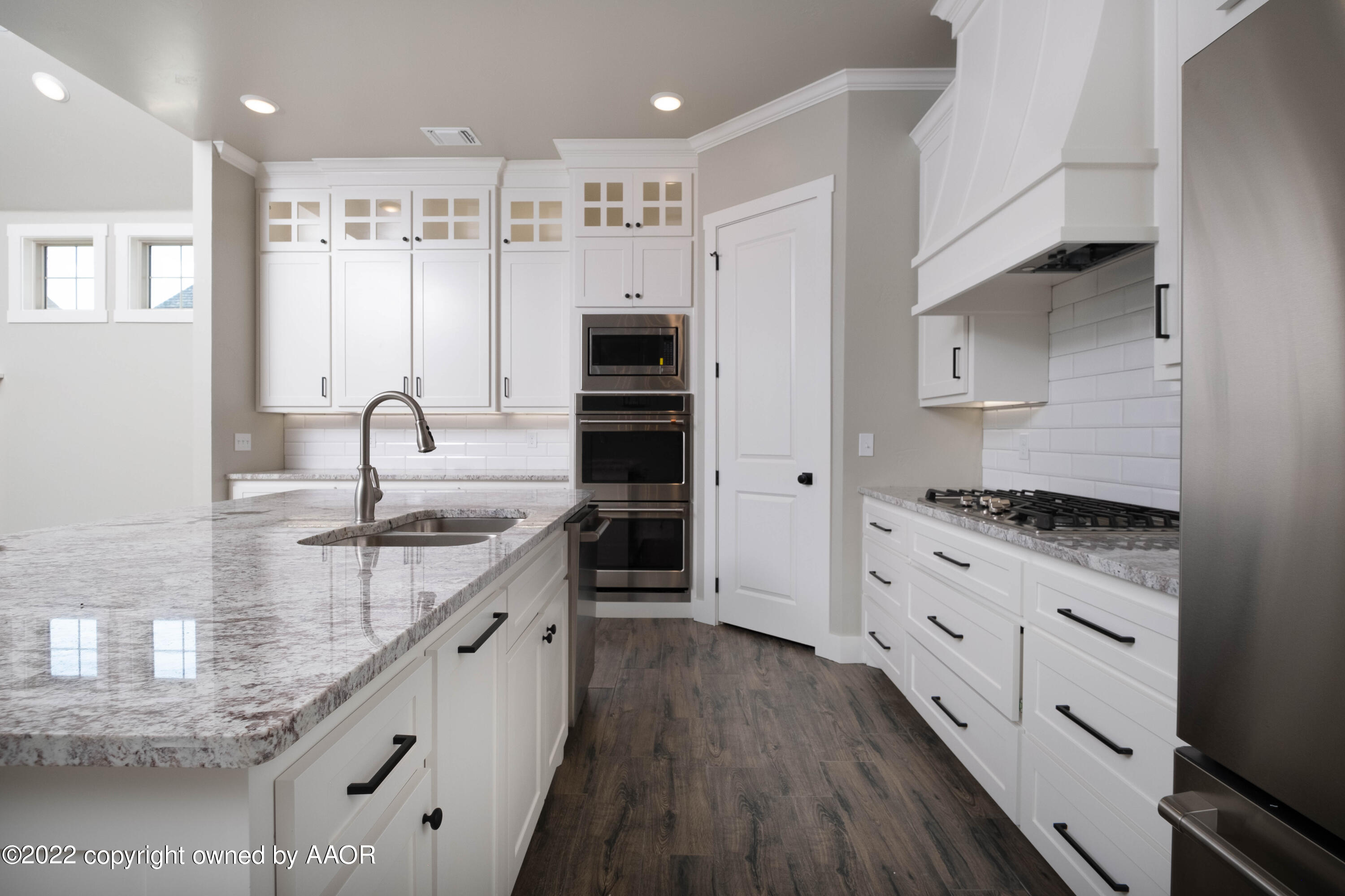 9414 Stonecrest Drive Amarillo, TX 79118 - Photo 18 of 60 a kitchen with granite countertop a sink stove and cabinets