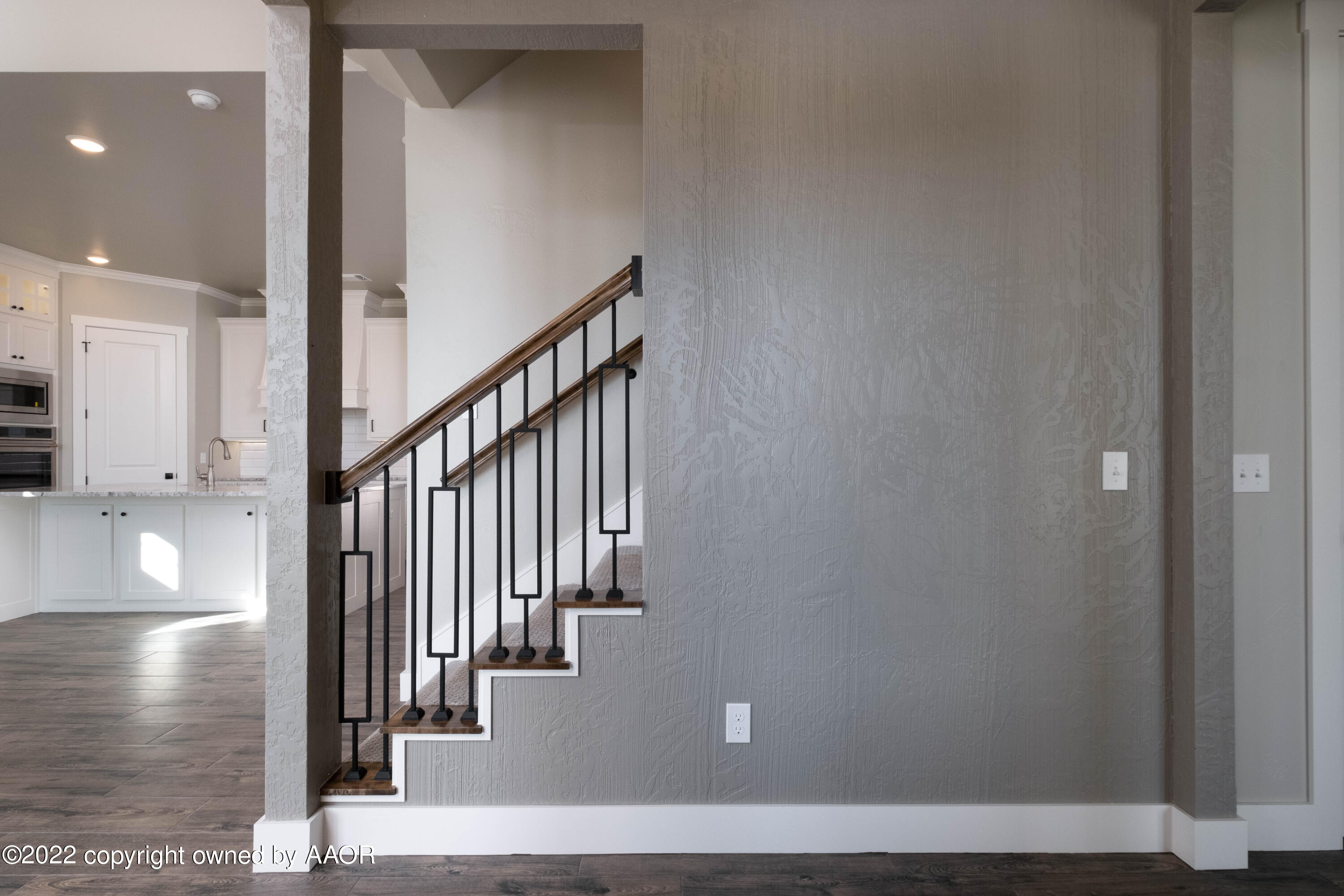 9414 Stonecrest Drive Amarillo, TX 79118 - Photo 25 of 60 a view of staircase with lots of frames on wall and stairs