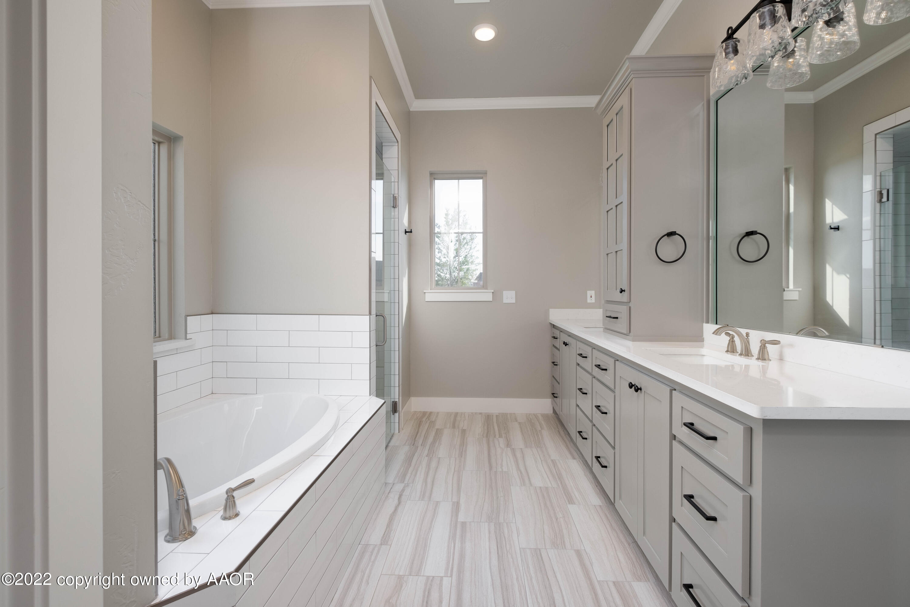 9414 Stonecrest Drive Amarillo, TX 79118 - Photo 32 of 60 a bathroom with a double vanity sink a mirror and a shower