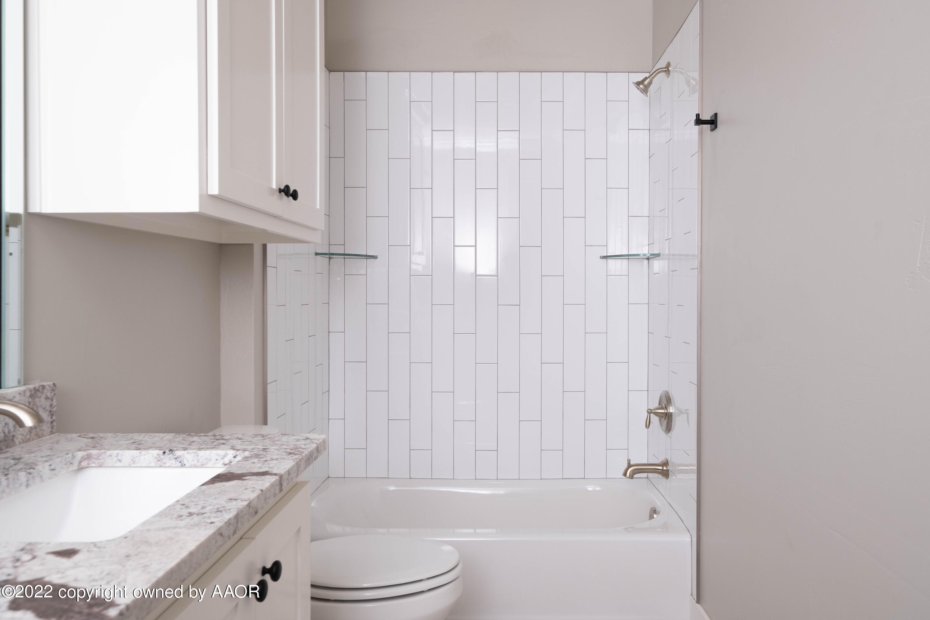 9414 Stonecrest Drive Amarillo, TX 79118 - Photo 46 of 60 a bathroom with a granite countertop sink toilet and shower