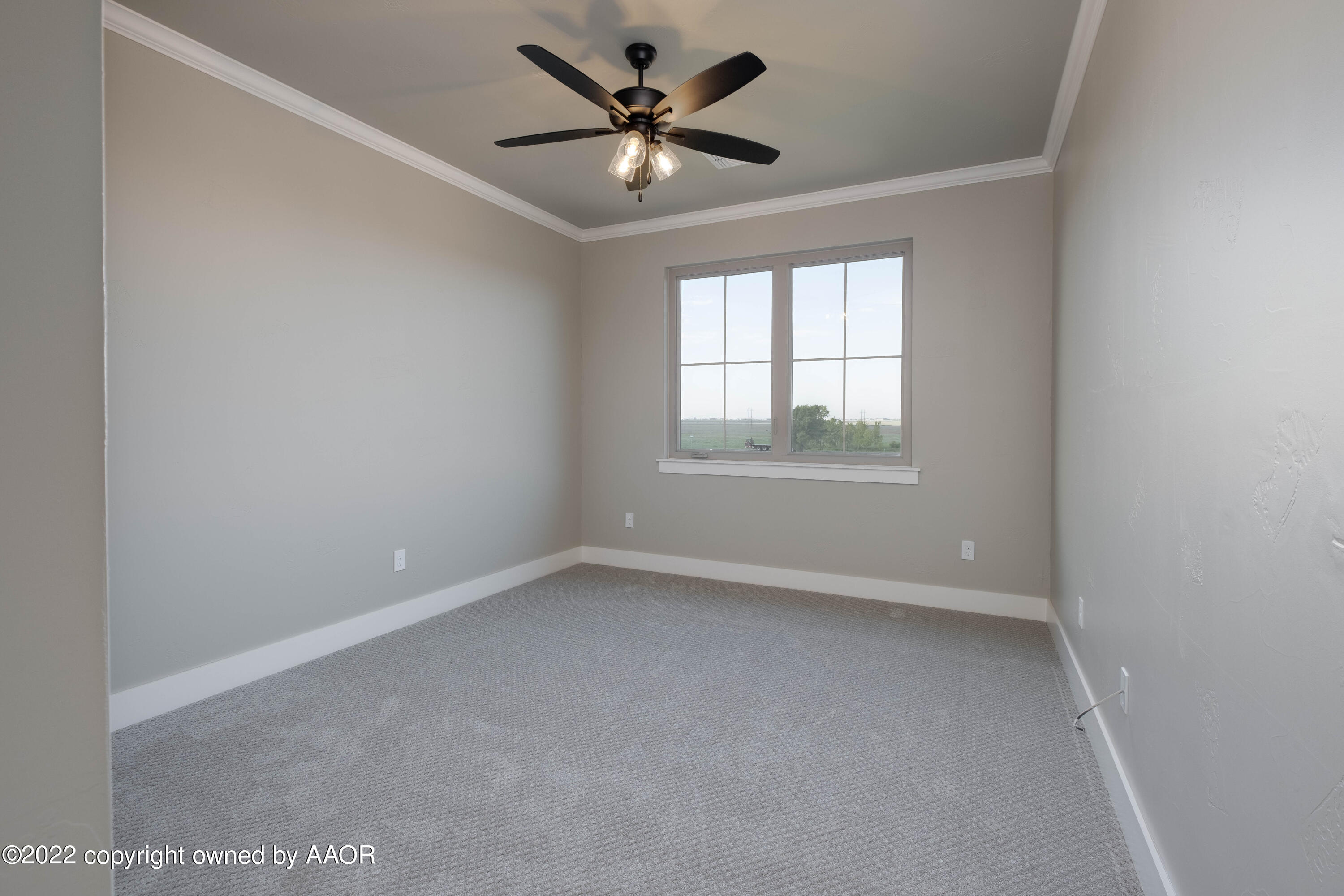 9414 Stonecrest Drive Amarillo, TX 79118 - Photo 49 of 60 an empty room with windows and ceiling fan