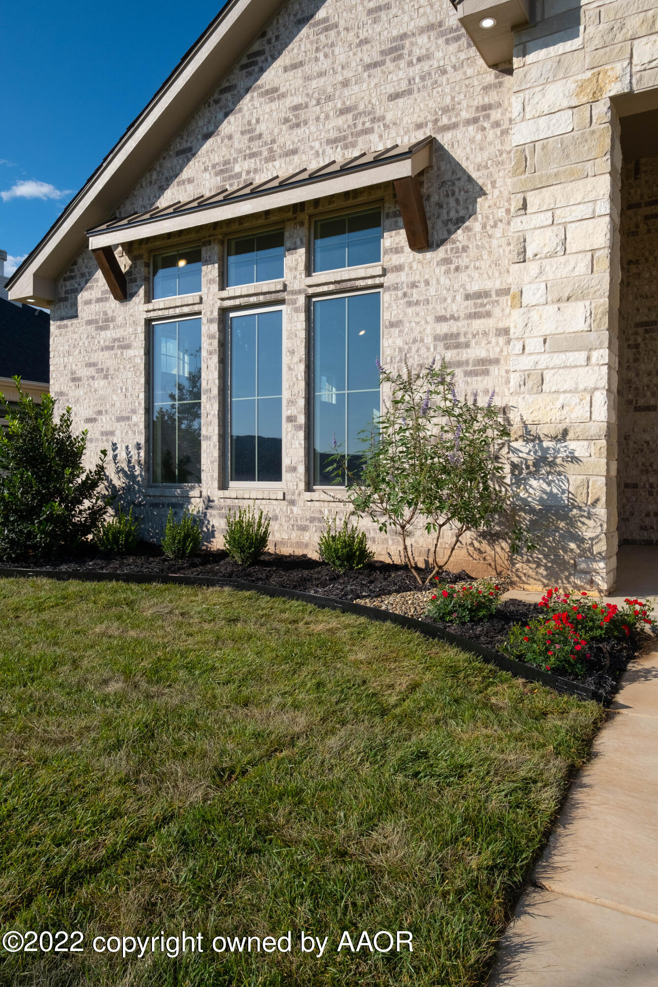 9414 Stonecrest Drive Amarillo, TX 79118 - Photo 6 of 60 a front view of a house with garden