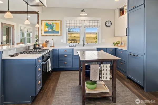 a kitchen with a wooden floor and a stove