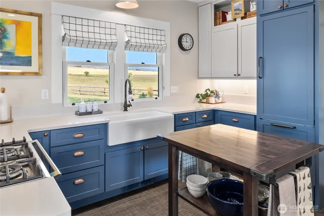 a kitchen with a stove and a wooden cabinets
