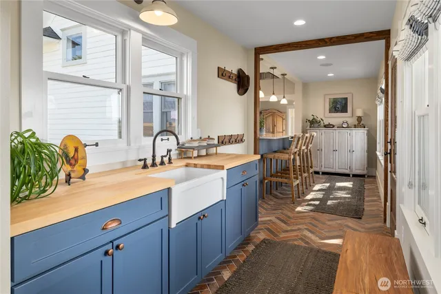 a view of a hallway with wooden floor and glass door