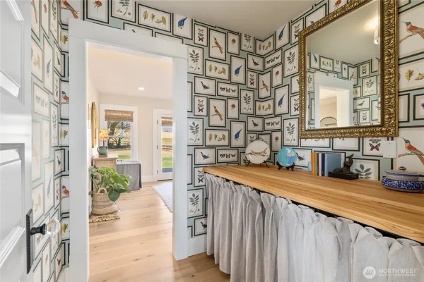 a bedroom with a bed and glass walk in closet