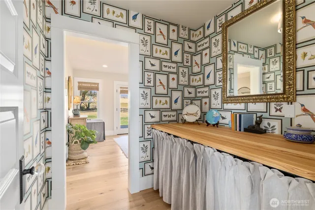 a bedroom with a bed and glass walk in closet