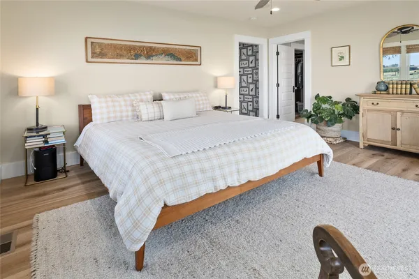 a spacious bathroom with a sink a mirror a bathtub and a large window