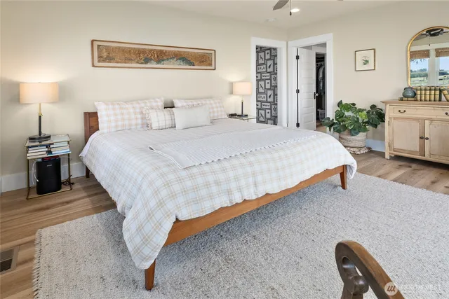 a spacious bathroom with a sink a mirror a bathtub and a large window