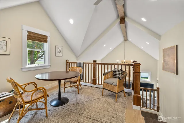 a living room with furniture a fireplace and a chandelier