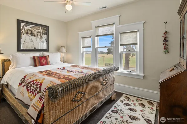 a bed sitting in a bedroom next to a window