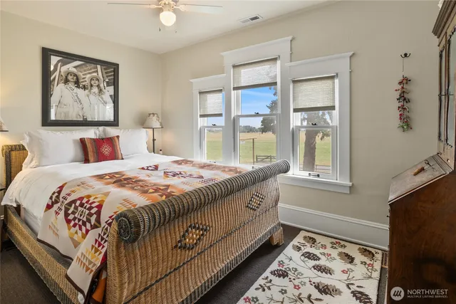 a bed sitting in a bedroom next to a window