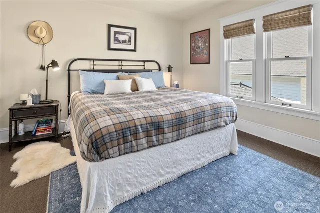 a view of a patio with table and chairs potted plants and large tree