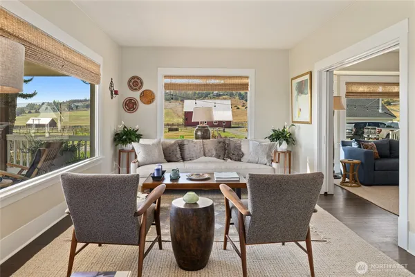 a living room with furniture and large windows