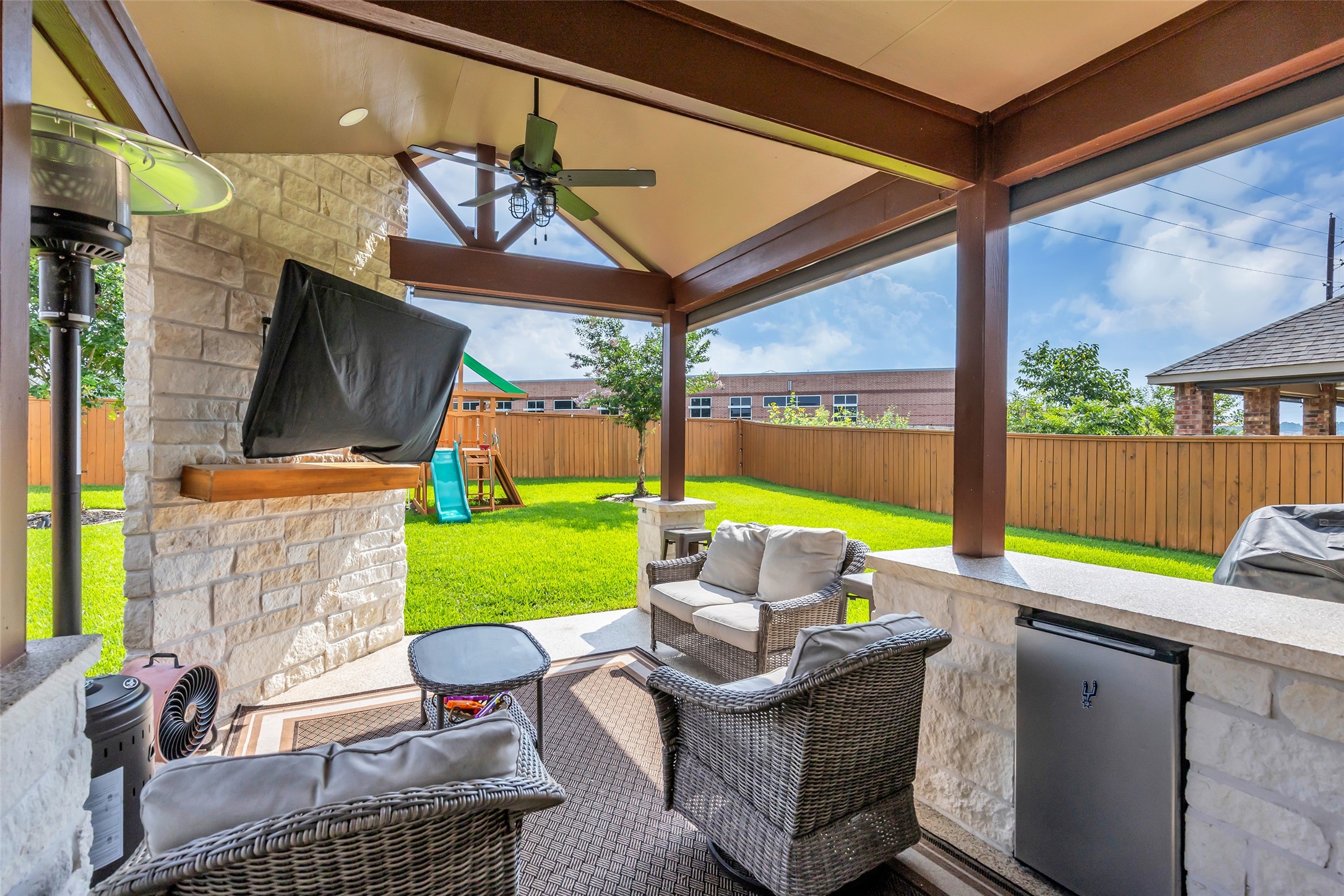 22907 Banff Brook Way Tomball, TX 77375 - Photo 20 of 26 At the back of the home is a covered patio that overlooks the entire backyard, providing a comfortable outdoor space for relaxing or entertaining.