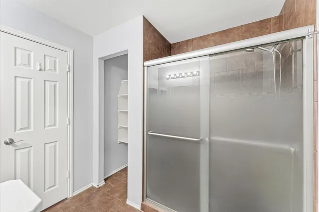 a bathroom with a glass shower door