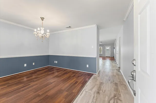 wooden floor in an empty room with a mirror