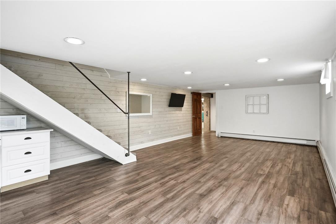 463 North Penn Dixie Road Bath, PA 18014 - Photo 39 of 86 A well-lit, finished basement with wide plank flooring offers versatile living space.