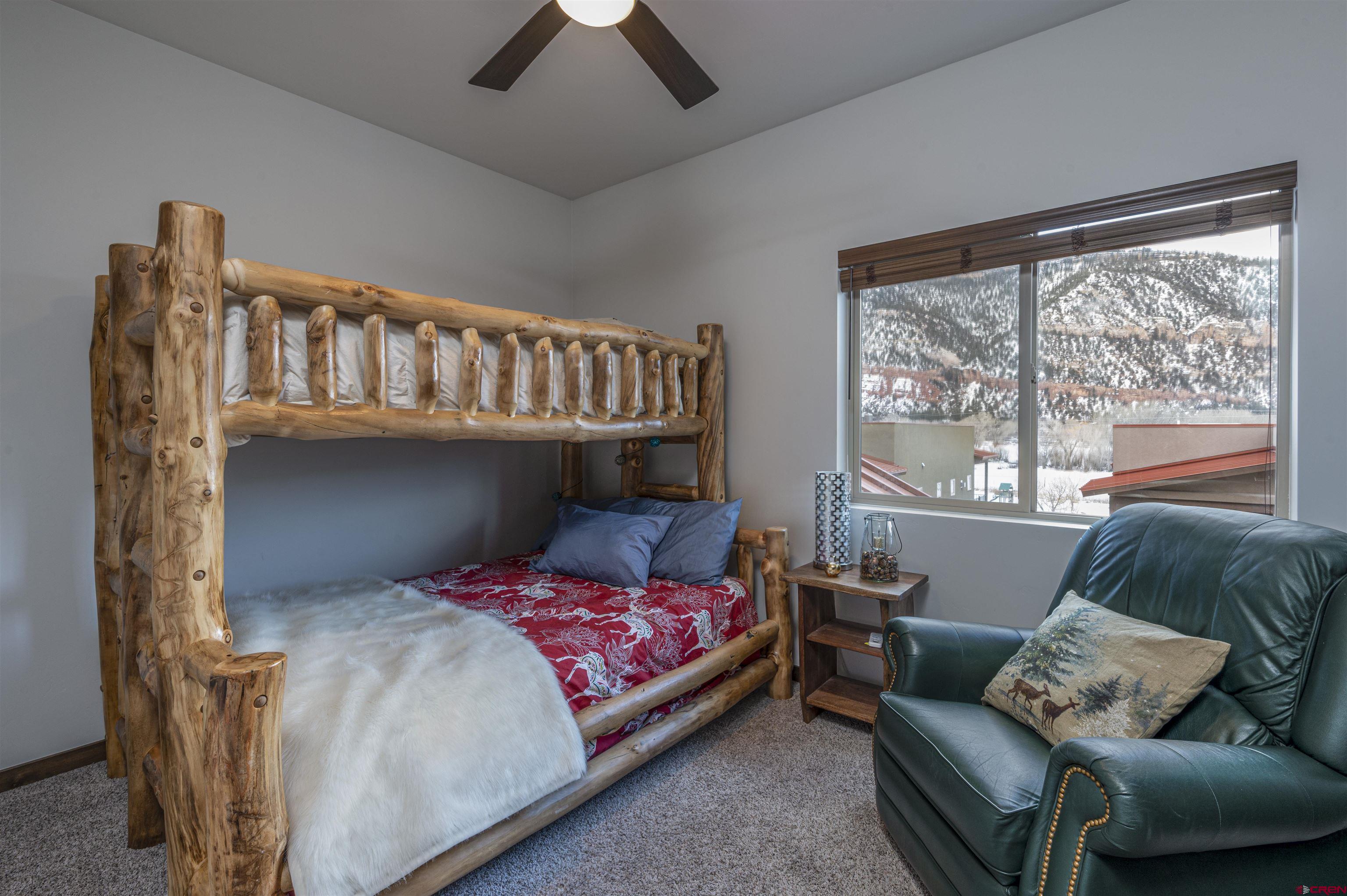 1422 Animas View Drive, Unit 24 Durango, CO 81301 - Photo 18 of 23 a bedroom with a bed couch and window