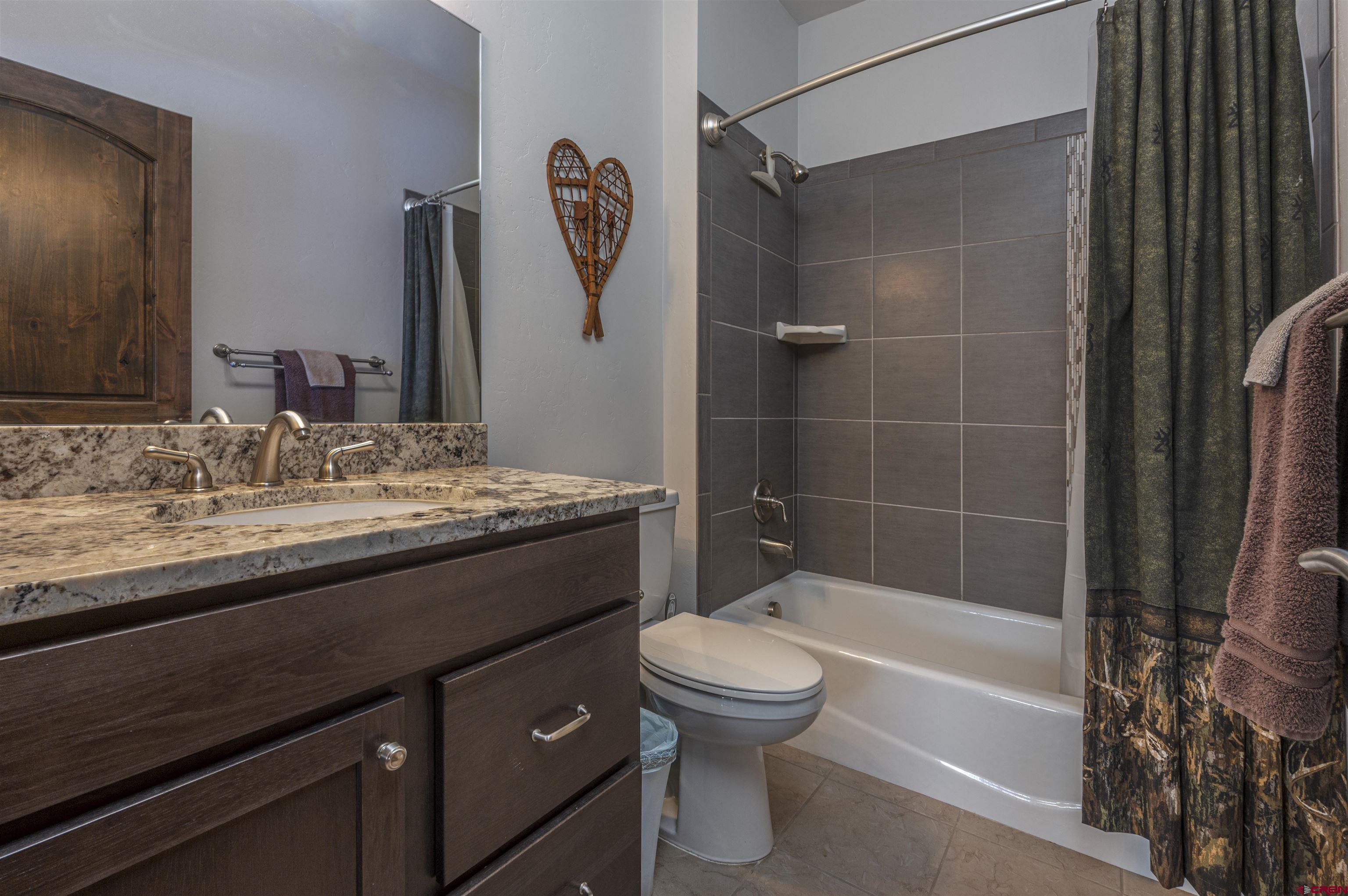1422 Animas View Drive, Unit 24 Durango, CO 81301 - Photo 19 of 23 a bathroom with a granite countertop sink toilet and shower