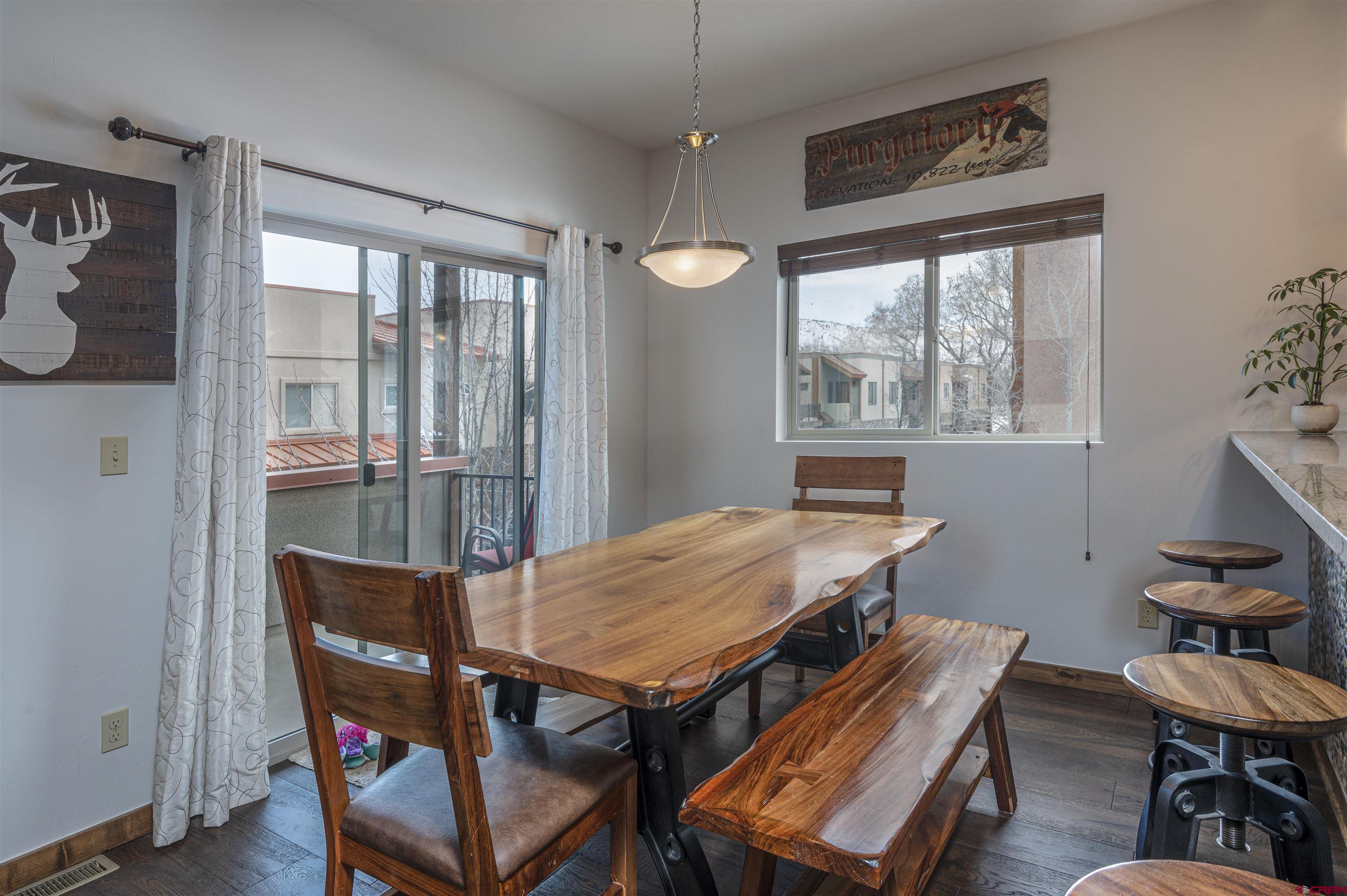 1422 Animas View Drive, Unit 24 Durango, CO 81301 - Photo 4 of 23 a view of a dining room with furniture window and wooden floor