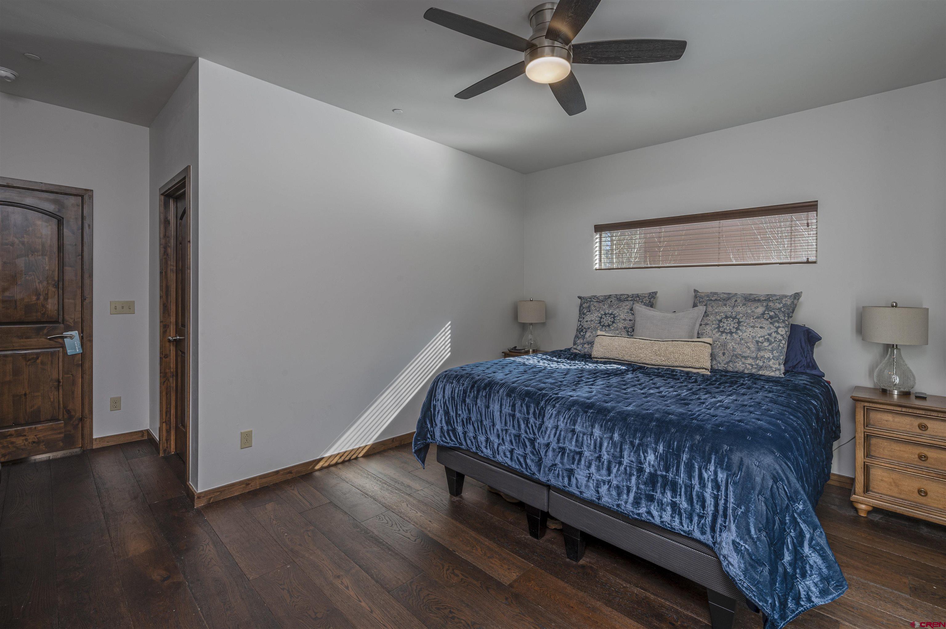 1422 Animas View Drive, Unit 24 Durango, CO 81301 - Photo 9 of 23 a bedroom with a bed and wooden floor