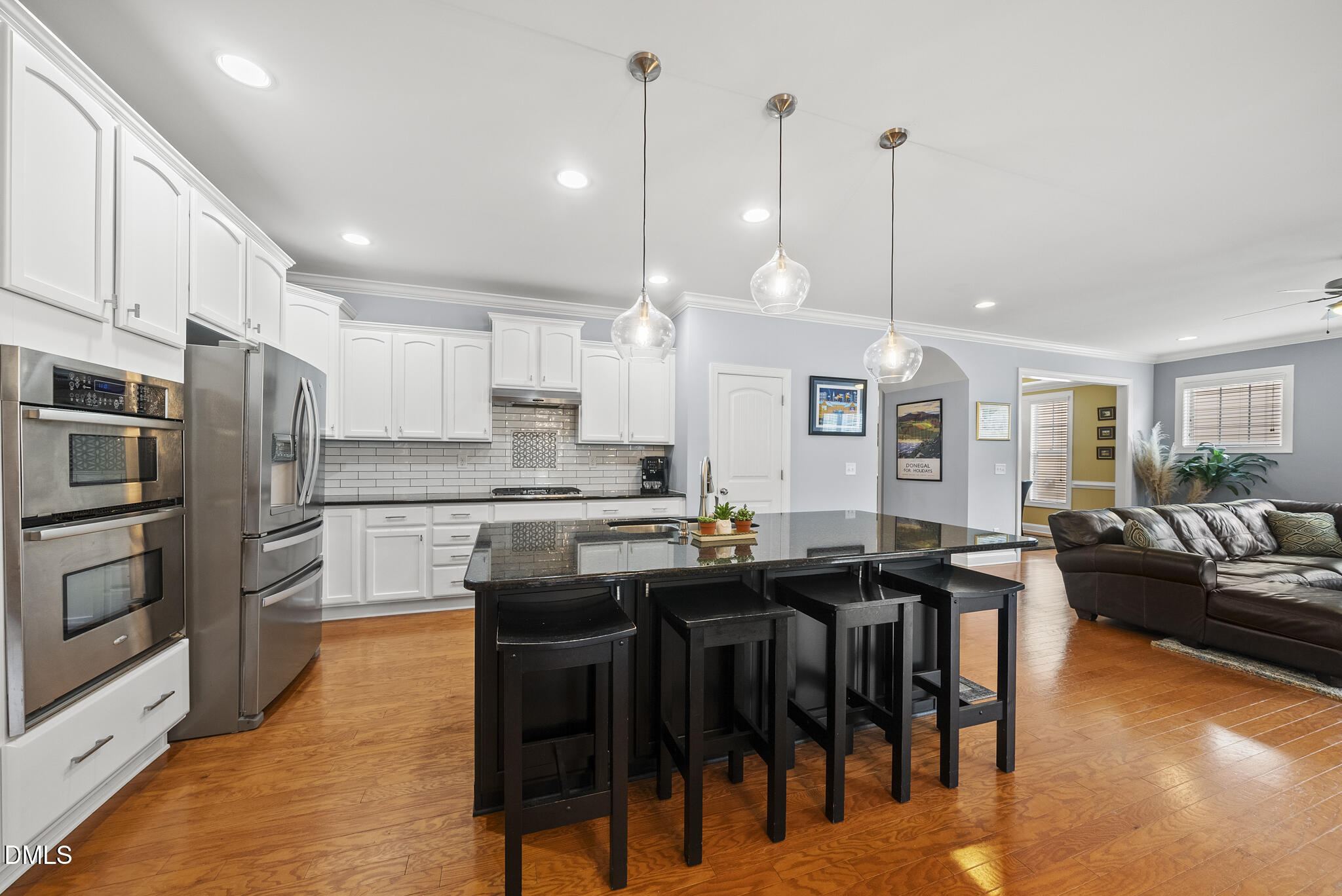 424 Powers Ferry Road Cary, NC 27519 - Photo 21 of 88 a kitchen with stainless steel appliances kitchen island granite countertop a table chairs sink and cabinets