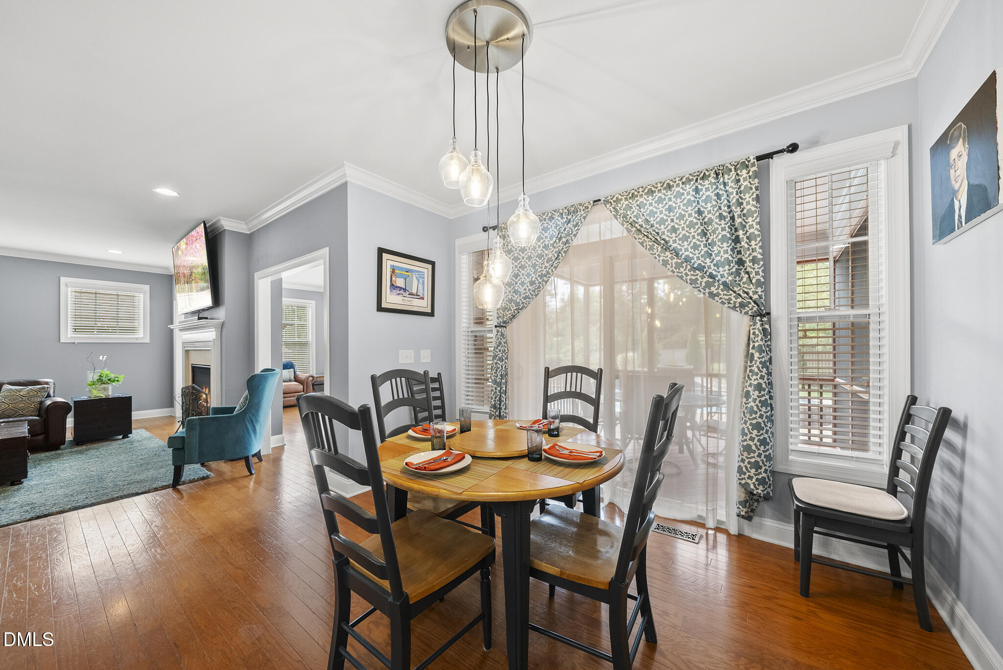 424 Powers Ferry Road Cary, NC 27519 - Photo 25 of 88 a dining room with furniture a chandelier and wooden floor