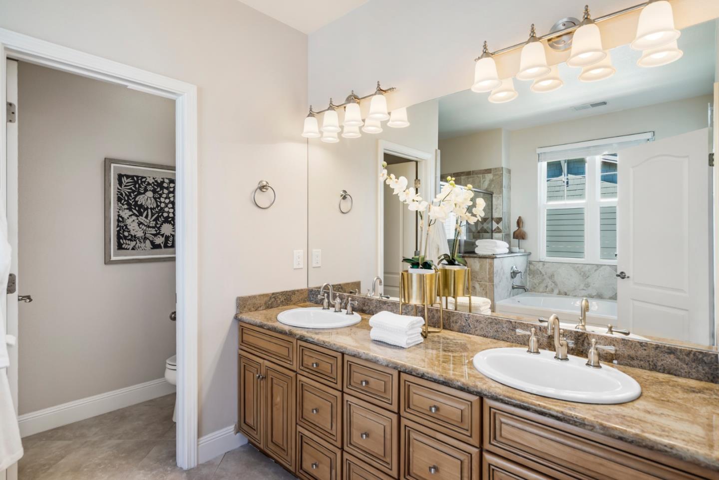 650 Willowgate Street Mountain View, CA 94043 - Photo 22 of 33 a bathroom with a granite countertop sink and a mirror