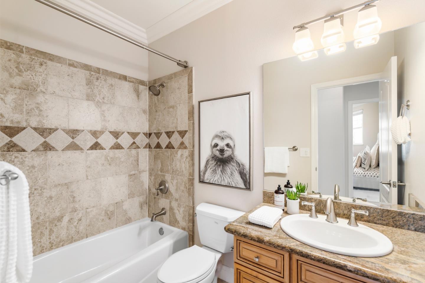 650 Willowgate Street Mountain View, CA 94043 - Photo 26 of 33 a bathroom with a granite countertop sink a toilet a mirror a bathtub and shower