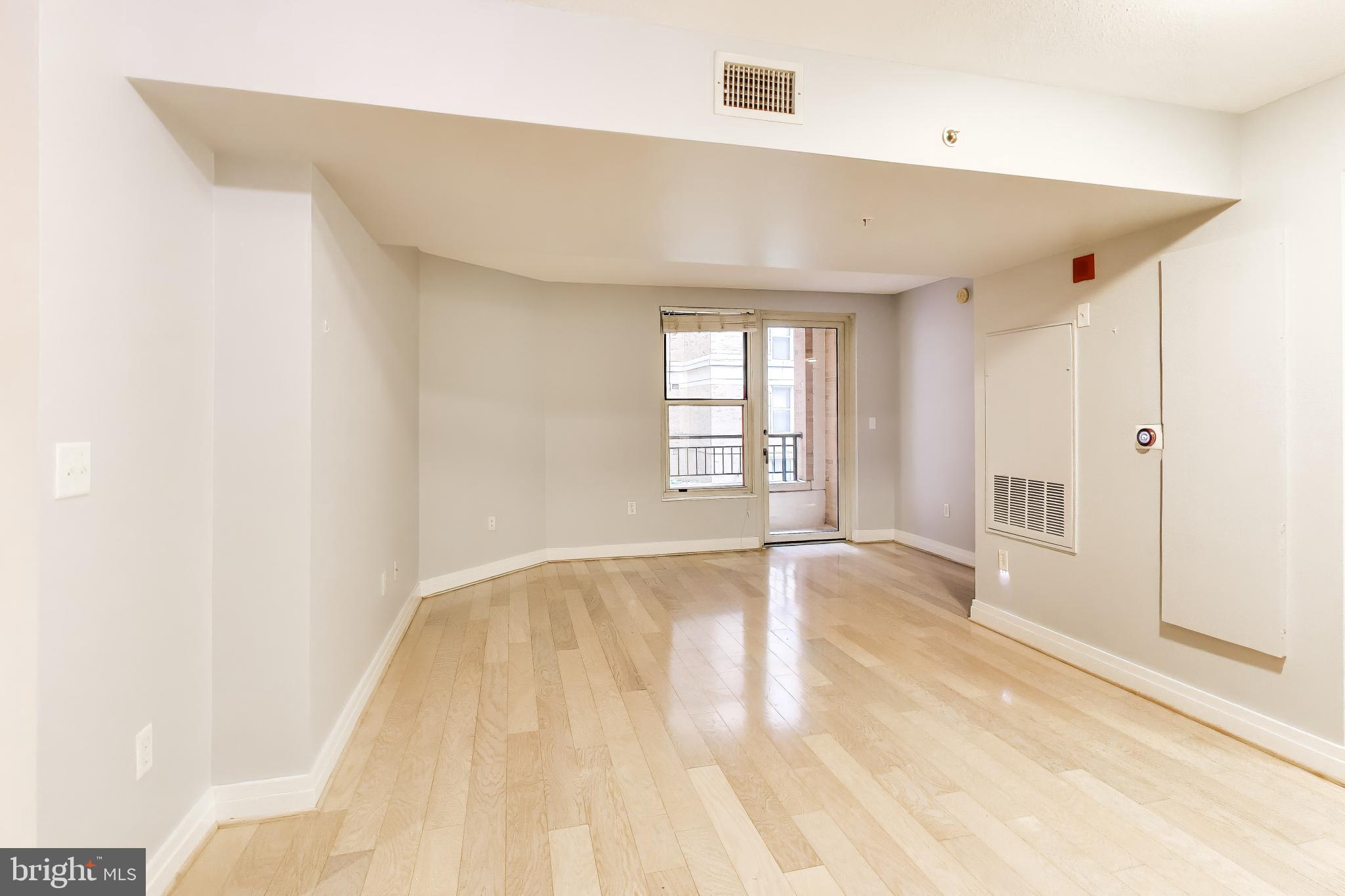 915 E Street Northwest, Unit 414 Washington, DC 20004 - Photo 8 of 35 a view of an empty room with wooden floor and a window