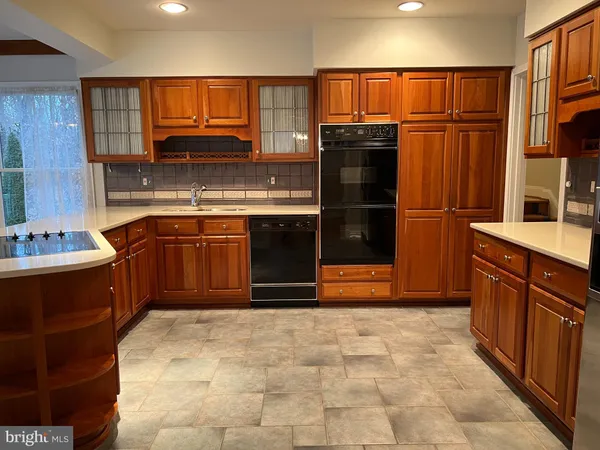 a kitchen with stainless steel appliances granite countertop a refrigerator stove and oven