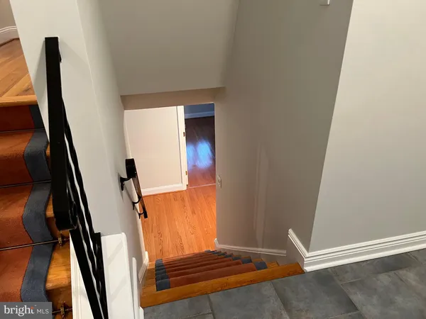 an empty room with wooden floor and closet